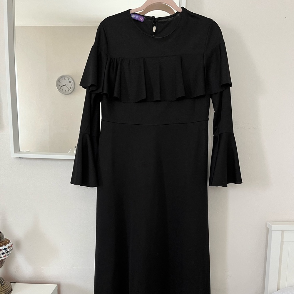 Black dress with flown design around the dress with flowy sleeves.